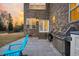 View of back patio with double doors, stainless grill, and outdoor seating, creating a perfect space for outdoor dining at 1106 Mccrae Dr, Moncks Corner, SC 29461