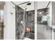 Modern shower featuring dark marbled walls, glass door, and dual shower heads at 1106 Mccrae Dr, Moncks Corner, SC 29461
