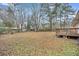 A spacious backyard with a deck and mature trees, offering privacy at 120 Carol Dr, Goose Creek, SC 29445