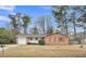 Charming single-story brick home with a well-maintained front yard, garage, and vibrant red shutters at 120 Carol Dr, Goose Creek, SC 29445