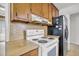 Cozy kitchen boasts wood cabinets and essential appliances, providing functionality and vintage style at 120 Carol Dr, Goose Creek, SC 29445
