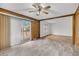 Inviting living room with wood paneling, tile flooring and sliding door access to the outdoor deck at 120 Carol Dr, Goose Creek, SC 29445