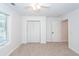 Bright bedroom featuring a neutral carpet, closet and a sunlit window at 123 White Picket Ln, Summerville, SC 29483