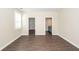 Bedroom featuring wood floors, large windows and doorway to walk-in closet and en suite bathroom at 123 White Picket Ln, Summerville, SC 29483