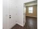 Entryway with a white door leading to a room featuring wood-look floors and a window at 123 White Picket Ln, Summerville, SC 29483