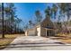 Exterior view of house with garage, concrete driveway, and surrounded by trees at 123 White Picket Ln, Summerville, SC 29483