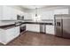 Bright kitchen with stainless steel appliances, modern white cabinets, and wood-look flooring at 123 White Picket Ln, Summerville, SC 29483