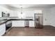 Modern kitchen with stainless steel appliances, white cabinets, and sleek countertops at 123 White Picket Ln, Summerville, SC 29483