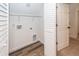 Well-lit laundry room with storage racks, hardwood floor, and washer-dryer hookups at 123 White Picket Ln, Summerville, SC 29483