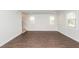 Open living area with wood-look flooring, large windows, and staircase at 123 White Picket Ln, Summerville, SC 29483