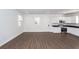 Bright living area with wood-look flooring, kitchen, and plenty of natural light at 123 White Picket Ln, Summerville, SC 29483