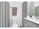 Bathroom featuring a striped shower curtain, toilet, and gray cabinet at 1241 Allusion Ln, Mount Pleasant, SC 29466