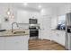Bright kitchen featuring white cabinetry, stainless steel appliances, and a large island at 1241 Allusion Ln, Mount Pleasant, SC 29466