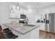 Well-lit kitchen features an island with bar seating, stainless steel appliances, and white cabinets at 1241 Allusion Ln, Mount Pleasant, SC 29466