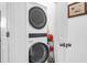 Convenient laundry area with stacked washer and dryer, and storage space at 1241 Allusion Ln, Mount Pleasant, SC 29466