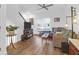 Well-lit living room boasts hardwood floors, a plush sectional couch, and a view of the staircase at 1241 Allusion Ln, Mount Pleasant, SC 29466