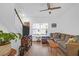 Bright living room features a large sectional couch, a ceiling fan, and hardwood floors at 1241 Allusion Ln, Mount Pleasant, SC 29466