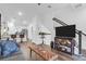 Open-concept living room with a large TV, hardwood floors, and access to the kitchen at 1241 Allusion Ln, Mount Pleasant, SC 29466