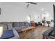 Open-concept living room featuring hardwood floors, a plush sectional couch, and a ceiling fan at 1241 Allusion Ln, Mount Pleasant, SC 29466