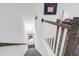 View of the white staircase, with decorative wood banister, going down to the front door at 1241 Allusion Ln, Mount Pleasant, SC 29466
