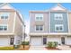 Exterior of townhomes featuring garages, front doors, and neutral color schemes at 1241 Allusion Ln, Mount Pleasant, SC 29466