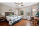 Cozy bedroom with hardwood floors, a ceiling fan, and a large window at 129 Isherwood Dr, Goose Creek, SC 29445