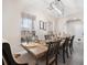 Elegant dining room featuring a modern chandelier, a wooden table set for six, and large windows at 129 Isherwood Dr, Goose Creek, SC 29445