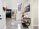 Bright foyer with white stairs, arched window, tiled floors, modern console table, and art at 129 Isherwood Dr, Goose Creek, SC 29445
