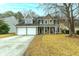 Charming two-story home featuring a two-car garage, well-kept lawn, and traditional architectural details at 129 Isherwood Dr, Goose Creek, SC 29445