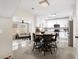Open kitchen with white cabinetry, stainless steel appliances, island seating, and adjacent living area at 129 Isherwood Dr, Goose Creek, SC 29445