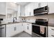 Well-lit kitchen with white cabinets, stainless steel appliances, granite countertops, and subway tile backsplash at 129 Isherwood Dr, Goose Creek, SC 29445