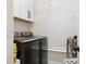 Modern laundry room features white cabinets, subway tile backsplash, and front load washer and dryer at 129 Isherwood Dr, Goose Creek, SC 29445
