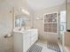 Bright main bathroom with double vanity, white cabinets, and separate shower at 129 Isherwood Dr, Goose Creek, SC 29445