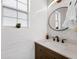 Stylish powder room with white subway tile, modern mirror, and wooden vanity at 129 Isherwood Dr, Goose Creek, SC 29445