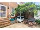 Cozy backyard with outdoor seating area, brick wall, and shade tree at 133 Wentworth St, Charleston, SC 29401