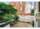 Backyard featuring a brick house, green bushes, and an outdoor dining set at 133 Wentworth St, Charleston, SC 29401