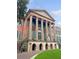 Classic building facade with grand columns, decorative details, and an American flag at 133 Wentworth St, Charleston, SC 29401
