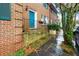 Brick townhouse with a vibrant blue door, green shutters, and classic architectural details at 133 Wentworth St, Charleston, SC 29401