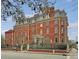 A stately brick building featuring multi-pane windows, a decorative roof, and wrought-iron fencing at 133 Wentworth St, Charleston, SC 29401