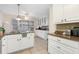 Spacious kitchen featuring white cabinetry, granite countertops, and a tile backsplash, perfect for culinary enthusiasts at 133 Wentworth St, Charleston, SC 29401