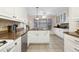 Well-lit kitchen featuring white cabinetry, granite countertops, and stainless steel appliances, creating a functional cooking space at 133 Wentworth St, Charleston, SC 29401