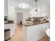 Bright kitchen featuring white cabinets, granite countertops, and tile flooring, offering a clean and efficient space at 133 Wentworth St, Charleston, SC 29401
