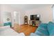 Bright living room featuring hardwood floors, a modern TV, and comfortable seating at 133 Wentworth St, Charleston, SC 29401