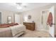 Main bedroom featuring a ceiling fan, a large bed, and access to the bathroom at 133 Wentworth St, Charleston, SC 29401