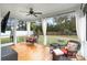 Relaxing screened porch with comfortable seating, a ceiling fan, and drapes for added privacy at 1502 Checker Ct, Mount Pleasant, SC 29466