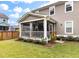 The screened-in porch is surrounded by flower beds and landscaping at 1502 Checker Ct, Mount Pleasant, SC 29466