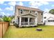 Well-maintained backyard with green grass, firepit, flowerbeds and a screened-in porch at 1502 Checker Ct, Mount Pleasant, SC 29466