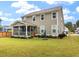 Beautiful backyard with a covered porch, green grass, an umbrella, and flower beds at 1502 Checker Ct, Mount Pleasant, SC 29466