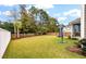 Spacious fenced backyard featuring a lush lawn, mature trees, and a patio area perfect for outdoor entertaining at 1502 Checker Ct, Mount Pleasant, SC 29466