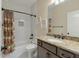 Bright bathroom with white tiled shower/tub combination and a granite countertop vanity at 1502 Checker Ct, Mount Pleasant, SC 29466